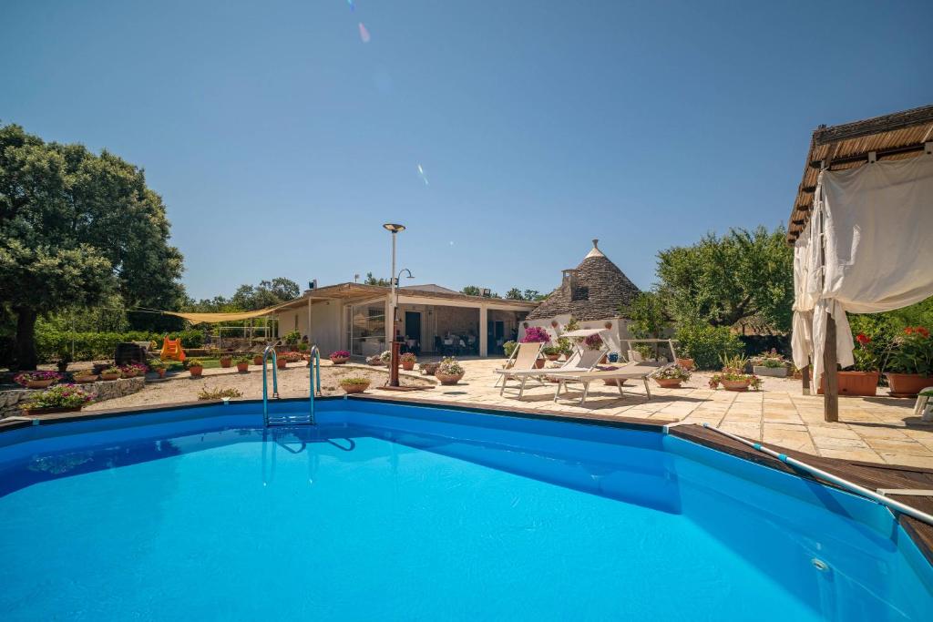 a swimming pool in front of a house at WePuglia - Canto dei Grilli in Noci