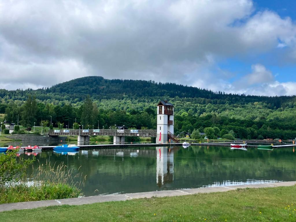 a lighthouse in the middle of a body of water at mieszkanie Akacjowa in Stronie Śląskie