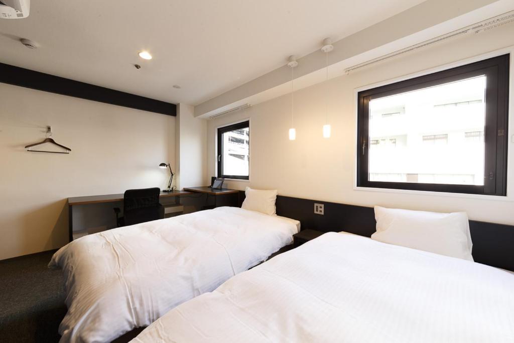 Postel nebo postele na pokoji v ubytování Hotel Citio Shizuoka