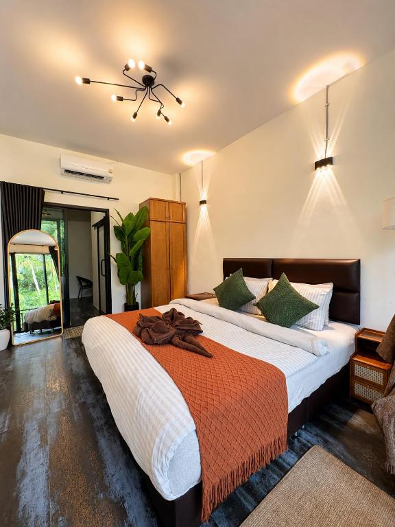 a bedroom with a large bed in a room at Jip Studio - 3mn ZenBeach - Garden View in Haad Chao Phao