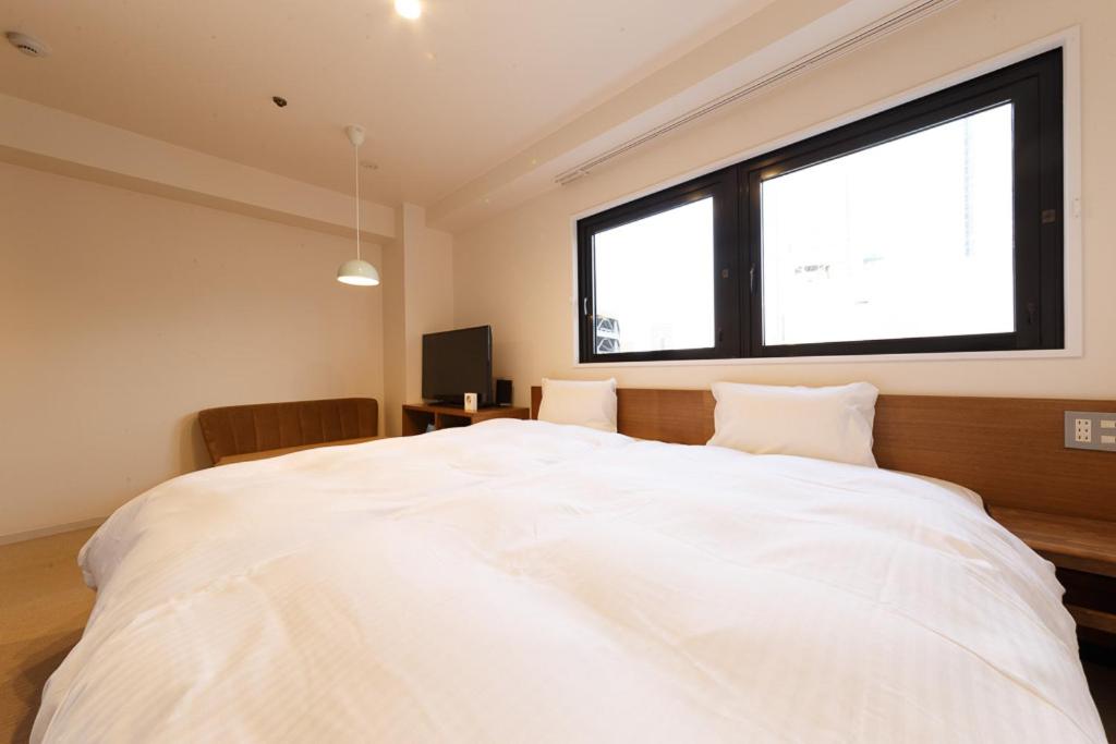 Postel nebo postele na pokoji v ubytování Hotel Citio Shizuoka