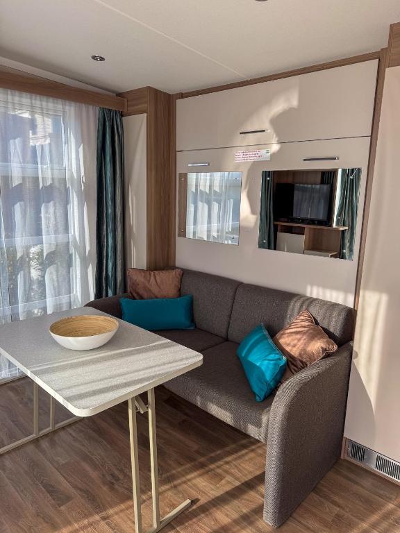 a living room with a couch and a table at UCamp Kemmelberg in Heuvelland
