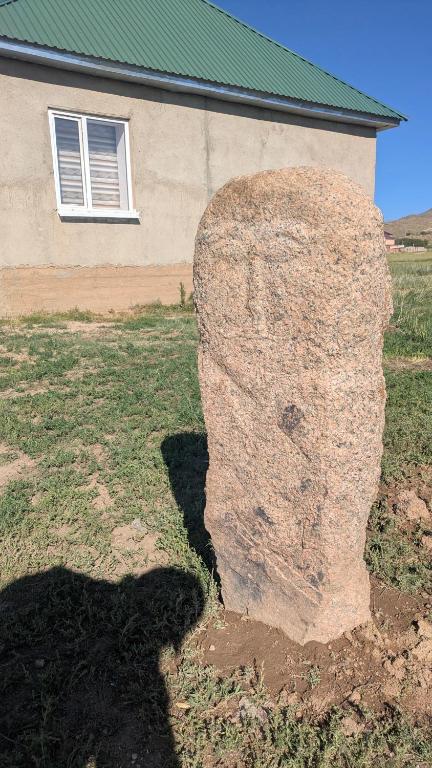 a large rock in front of a building at Koch Iz guest house in Kochkorka