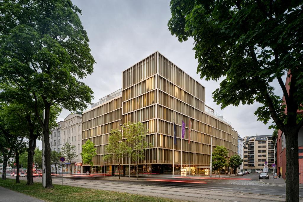 a tall glass building on a city street at MAXX by Steigenberger Vienna in Vienna