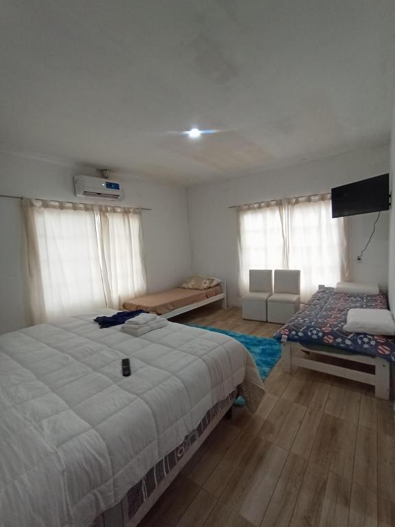 a bedroom with a bed and a television in it at Hotel Maipú in Maipú