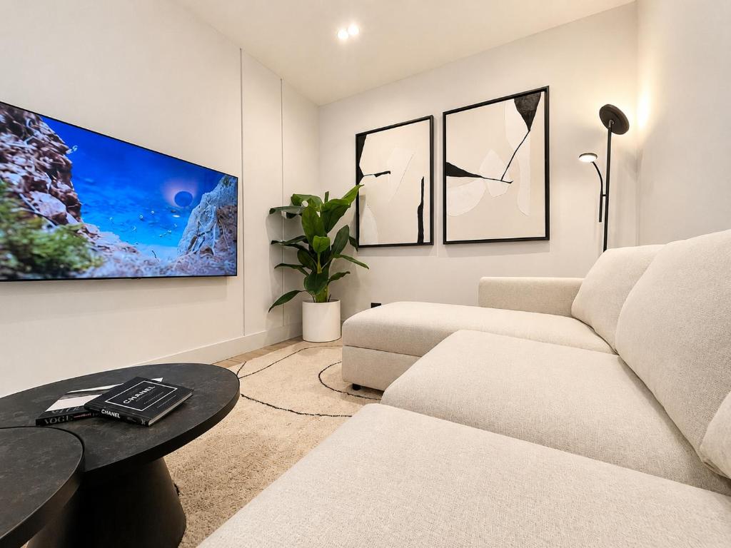 a living room with a couch and a table at Garibaldi Suite 2 Renovated 1BR with Parking, Old Town Olbia in Olbia