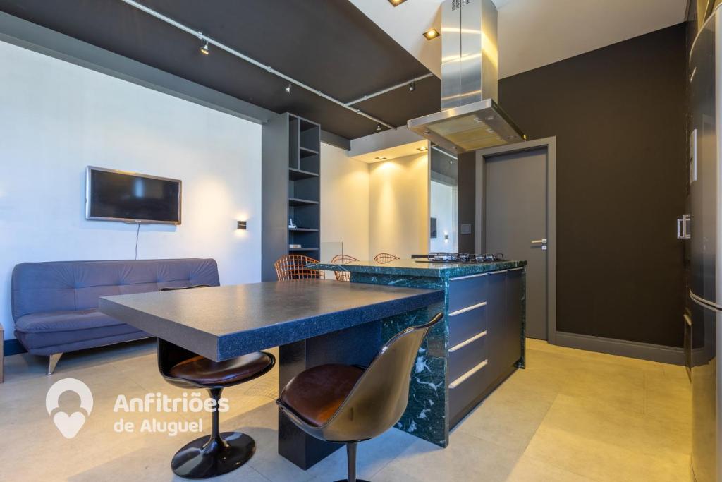 a kitchen with a blue counter top and a table at Cobertura Duplex Vista Cidade Centro TV4061 in Blumenau