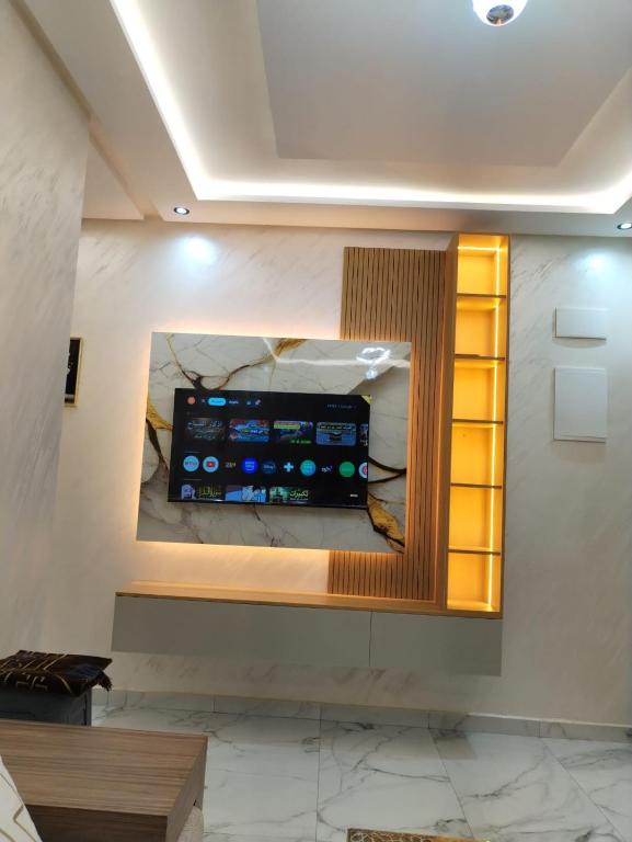 a mirror on a wall with a television on it at Apprtmnt jury de luxe 6 in Nador