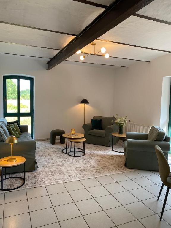 a living room with couches and tables at Smeers Hof in Böhme
