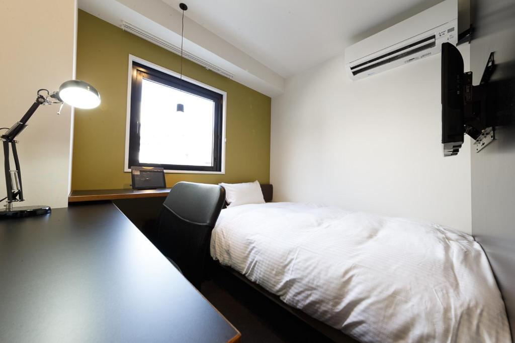 Postel nebo postele na pokoji v ubytování Hotel Citio Shizuoka