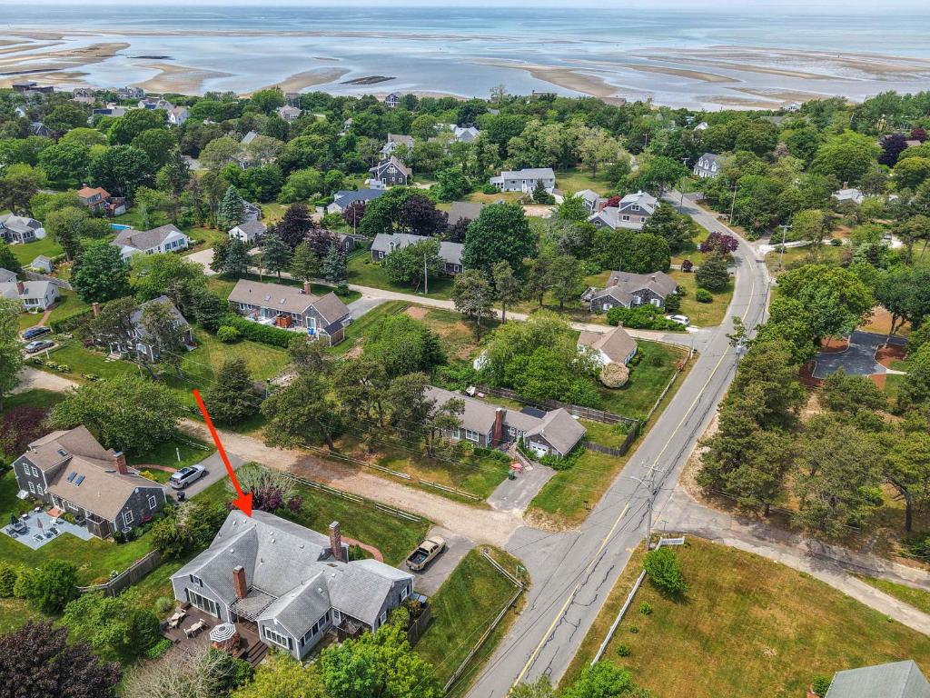 an aerial view of a neighborhood with houses and the ocean at Steps to Bayside Beach Central AC Large Backyard in Brewster