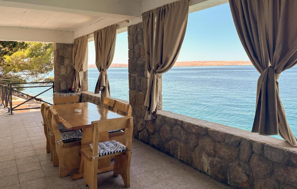 a dining room with a view of the water at Nice Home In Karlobag With Wifi in Karlobag