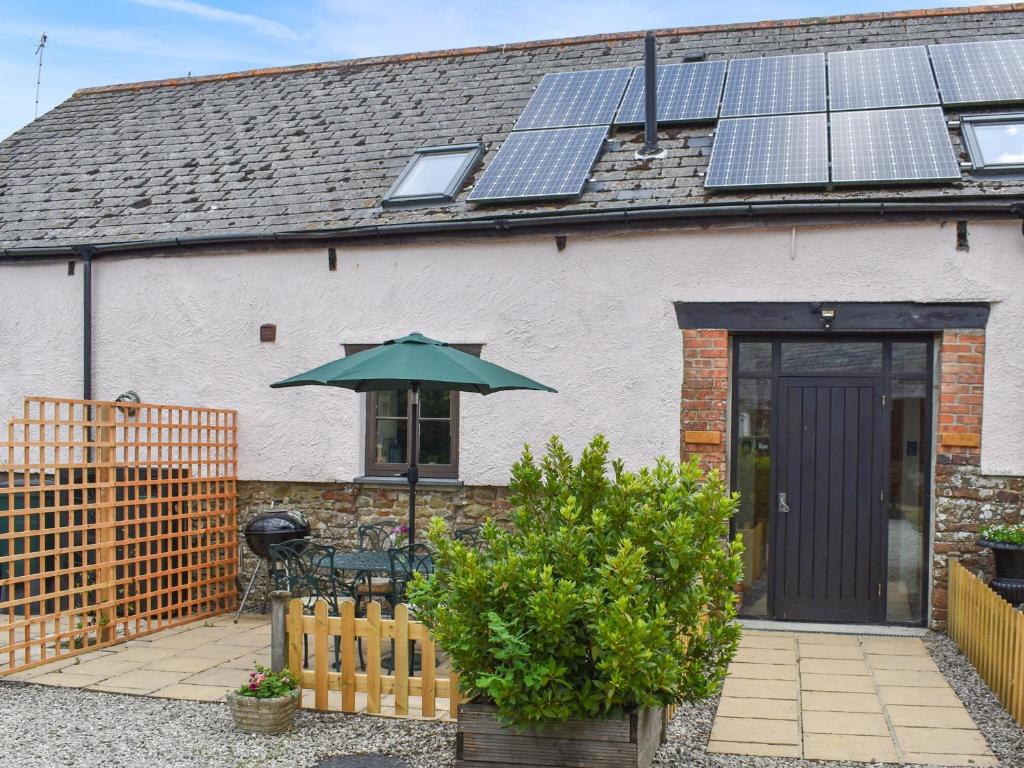 a house with solar panels on the roof at Bridge Cottage - Ukc9516 in Sheepwash