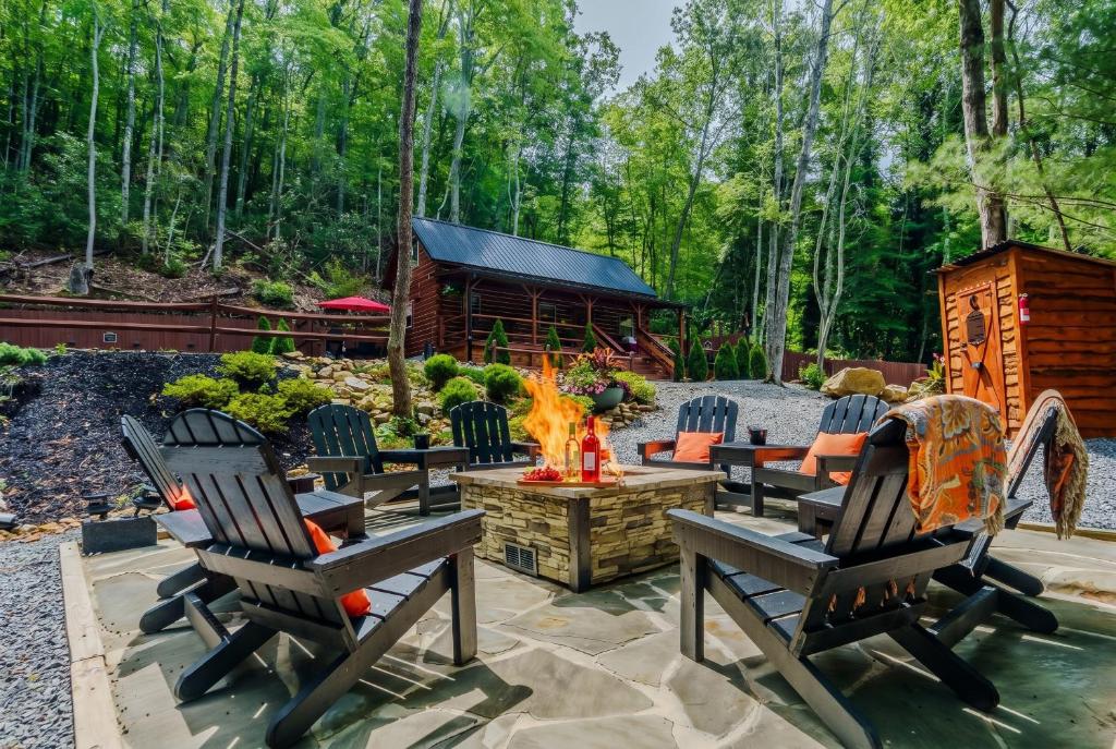 a patio with chairs and a fire pit and a cabin at Peaceful Luxury in the Smokey Mountains w Hot Tub and Pet Friendly Cabin B in Elizabethton
