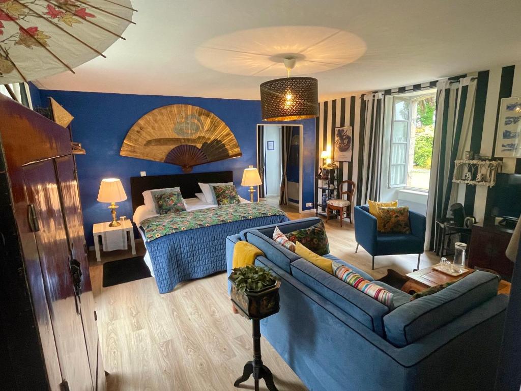 a bedroom with a bed and a couch in a room at Chambres De St Michel in Paimpol