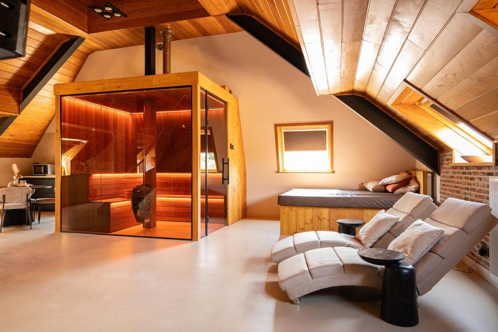 a living room with a vaulted ceiling and a couch at Vakantiewoning - Camping Groenpark in Berlare