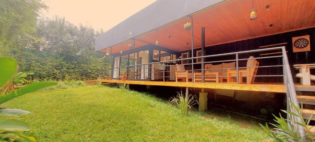 a large building with a grassy field next to it at Barnhouse Cottage - Sauna & Steam bath - in Tigoni in Nairobi
