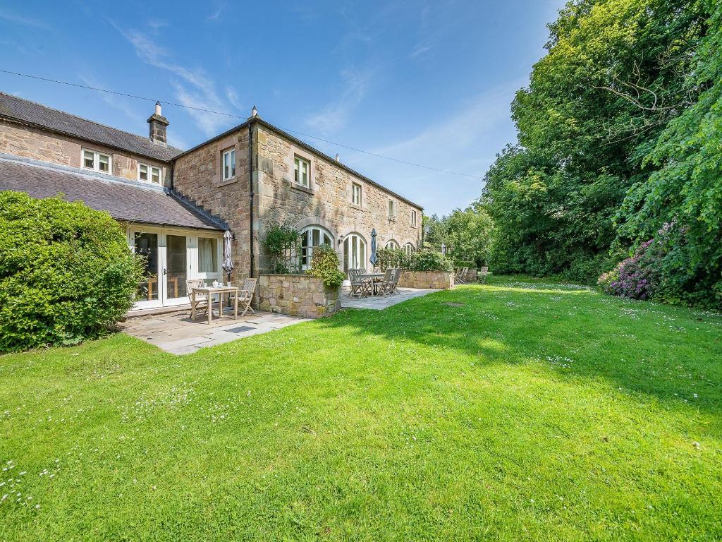 a large brick house with a grass yard at Shellrigg - Uk49891 in Preston