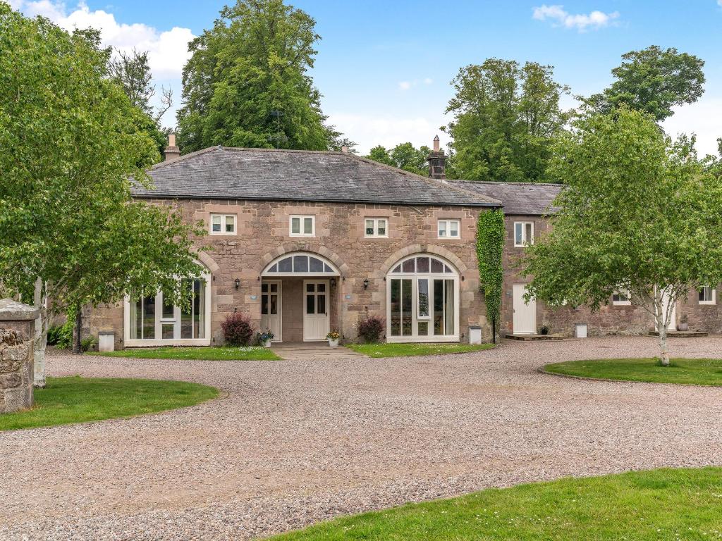an old stone house with a driveway at Coach House - Uk49887 in Preston