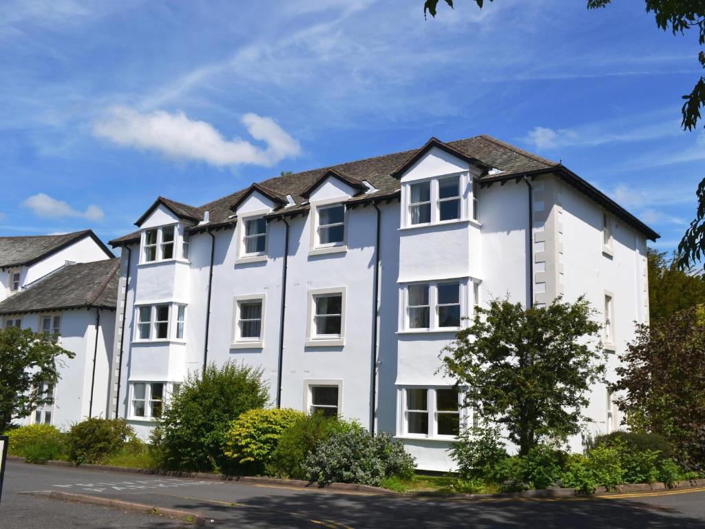 a white apartment building with a row of windows at Flat 2 Lonsdale House in Keswick