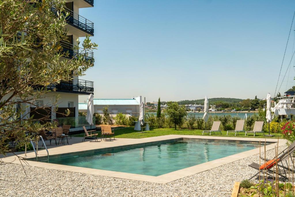 a swimming pool on the side of a building at Golden Tulip Hotel & Rooftop Martigues Provence in Martigues