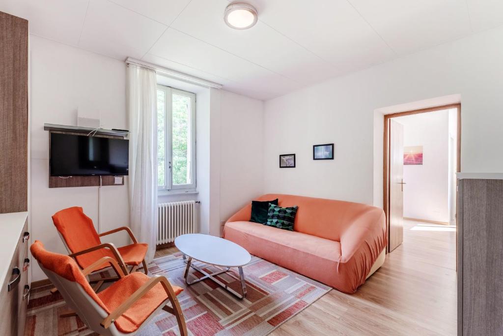 a living room with a couch and a table at La Pergola by Quokka 360 - Cozy Stay for Mountain Adventures in Leventina in Lavorgo