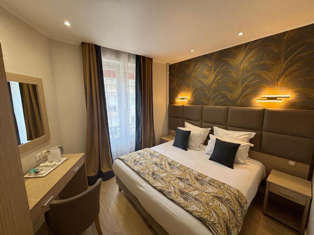 a hotel room with a large bed and a window at Hotel Riviera OPERA Cadet in Paris