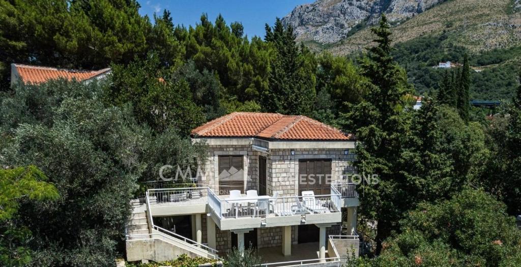 a large house with a balcony on a mountain at Villa Masha in Rijeka Reževići