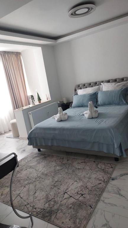 a bedroom with a bed with two stuffed animals on it at City Hall Deluxe Studio in Craiova