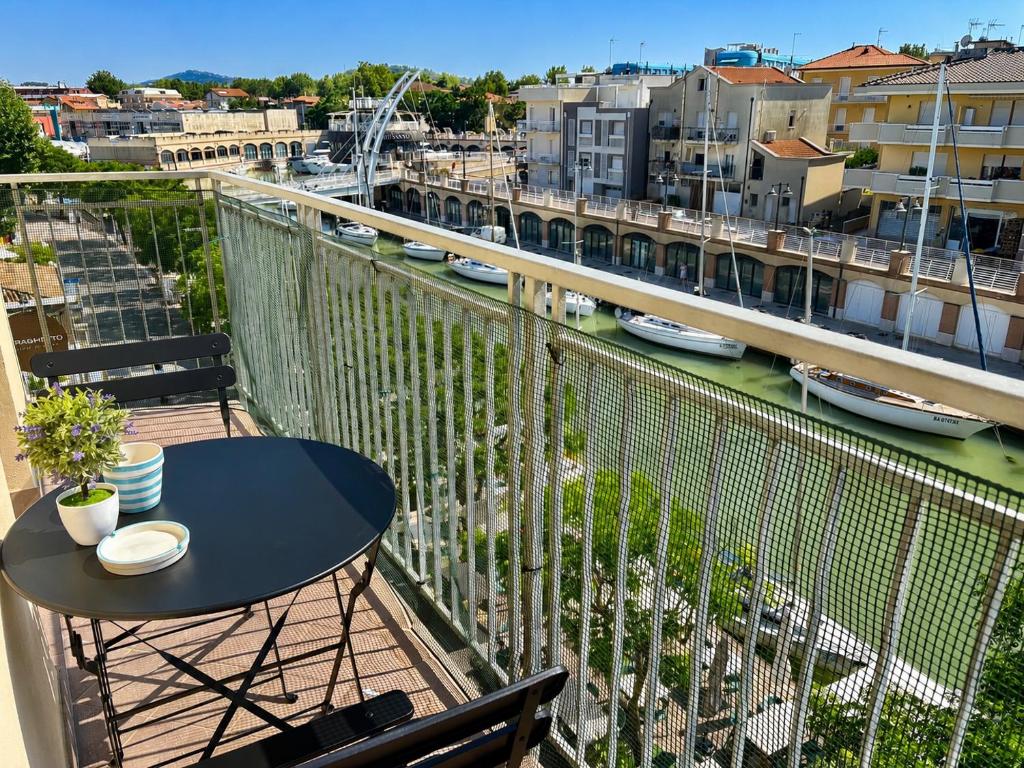 a balcony with a table and a view of a city at De Amicis Sea Home in Gabicce Mare