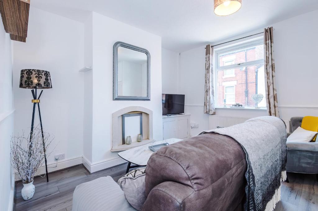 a living room with a couch and a table at Stylish 2-Bed House Sleeps 4 in Saint Helens