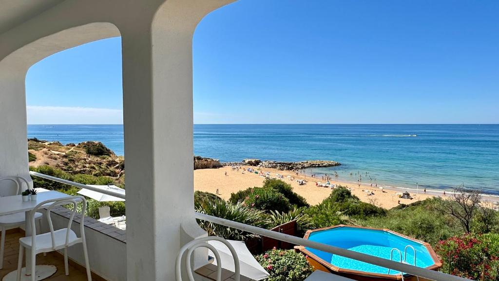 a view of the beach from the balcony of a house at Beira Mar - Private Pool - 7 Guests - Albufeira in Albufeira