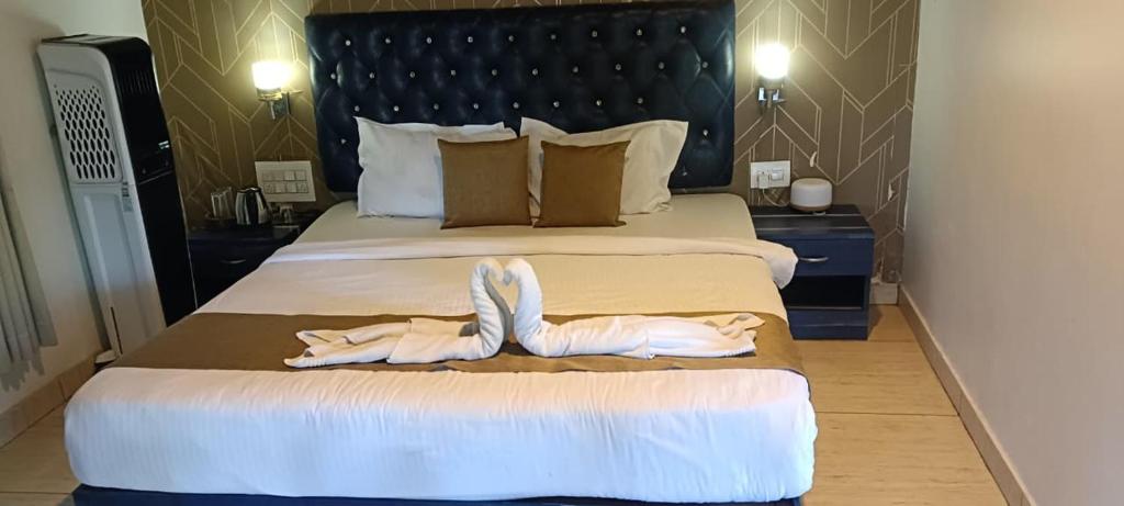 a woman is laying on a bed in a hotel room at Mountain Cottages Coorg in Madikeri