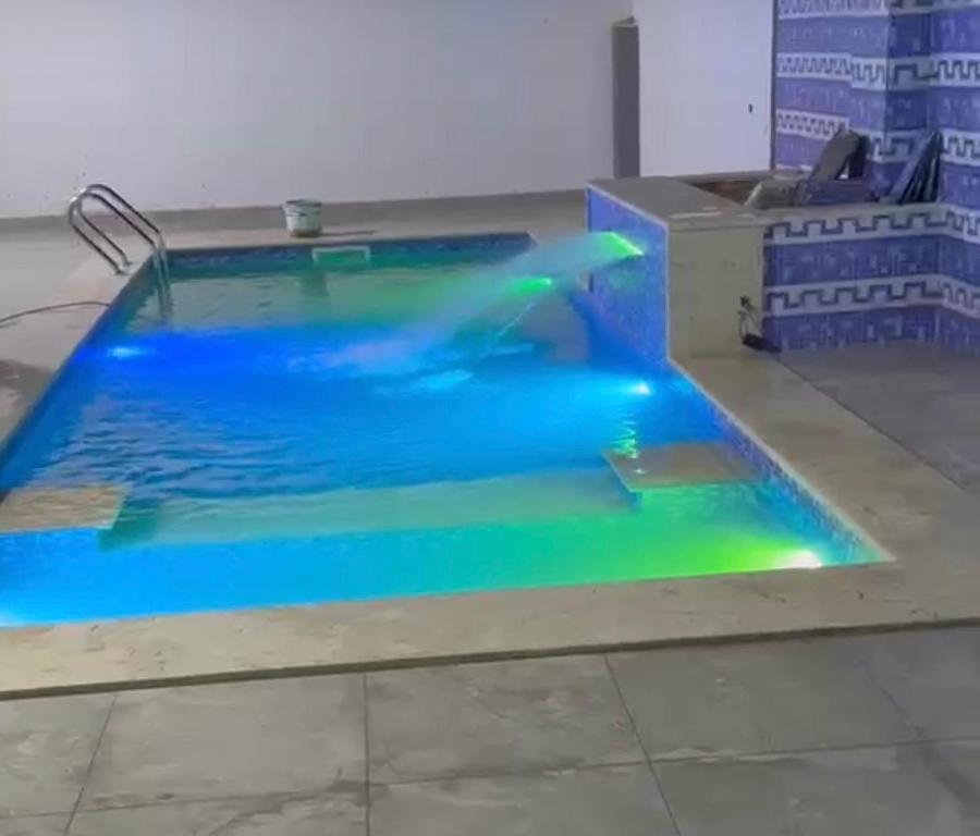 a swimming pool with blue and green illumination at Venice Private Retreat Tripoli, Libya in Tripoli