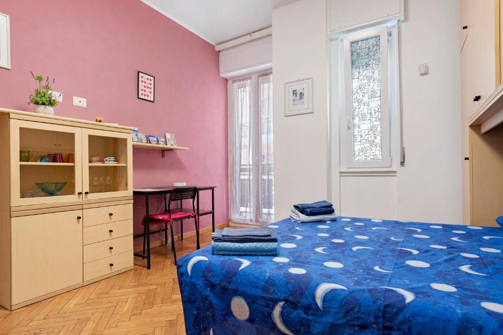 a bedroom with a bed and a desk in it at La Casetta di G&G in Varese