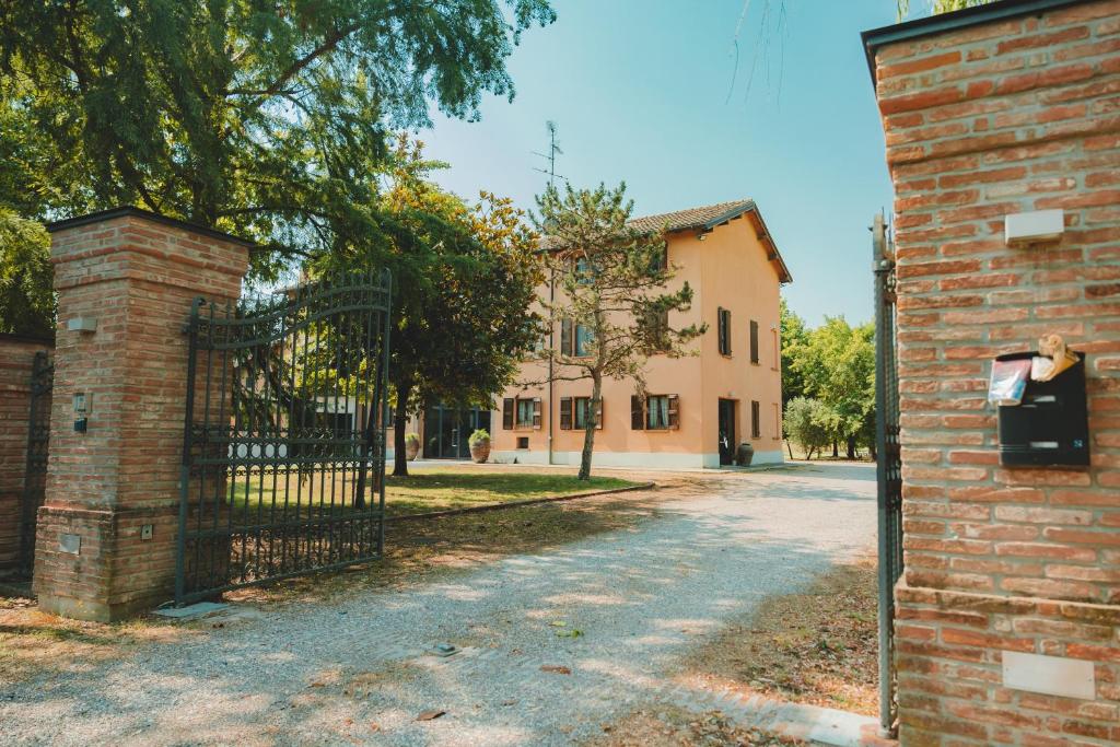 an entrance to a brick building with a gate at Black Paradise Room in Soliera