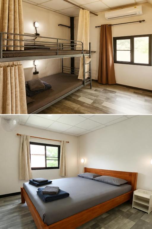 a bedroom with two bunk beds in a room at PaiPaiHostel in Pai