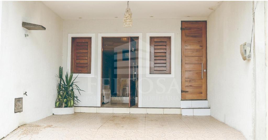 a front door of a house with a potted plant at Varanda Atlantica Casa Camocim enfrente a praia in Camocim