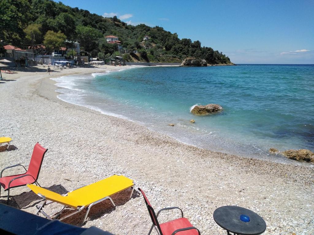a group of chairs on a beach near the water at Eternal blue in Volos