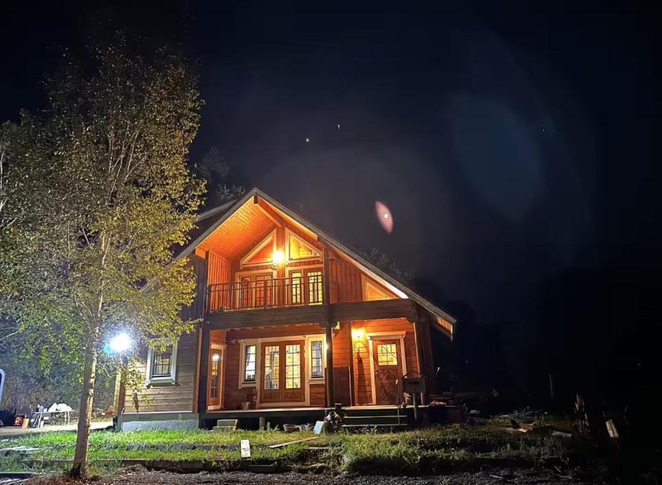 a large wooden house at night with a light at Furano Private Villa Runway 15 in Wada