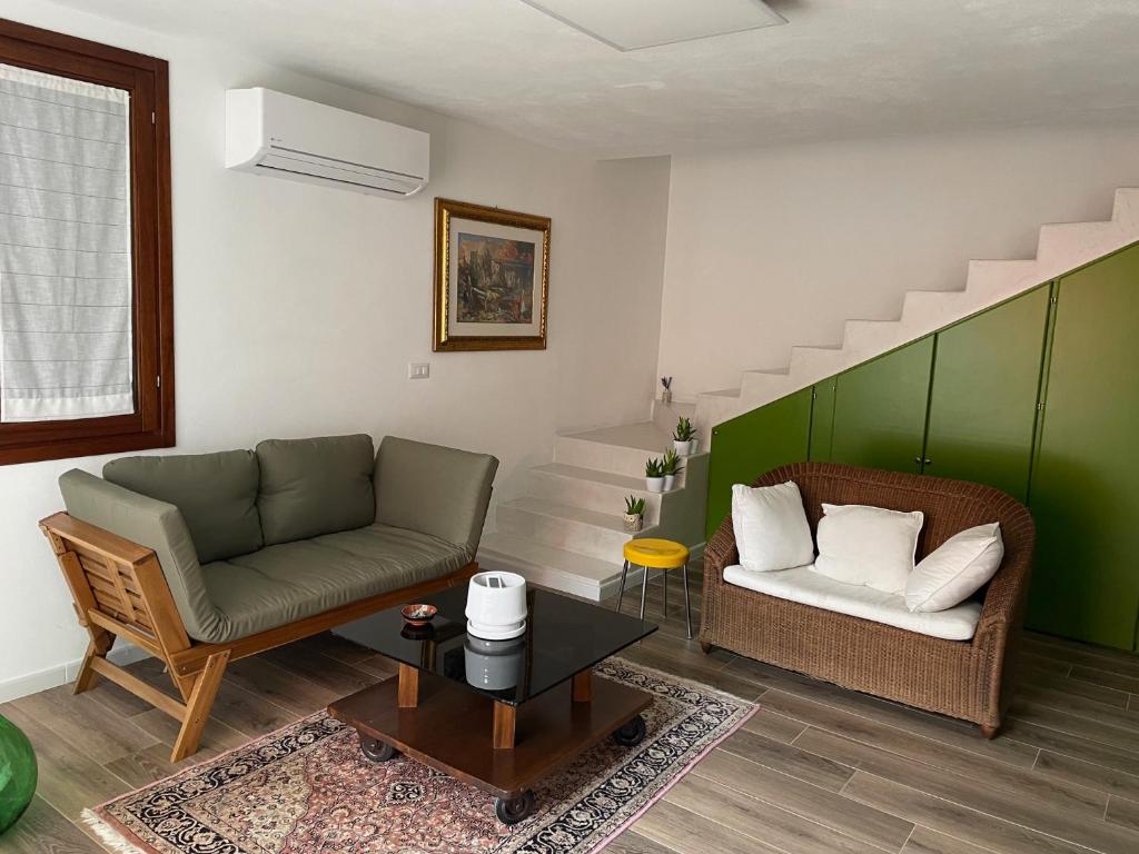 a living room with a couch and a table at Casa natura in Usini