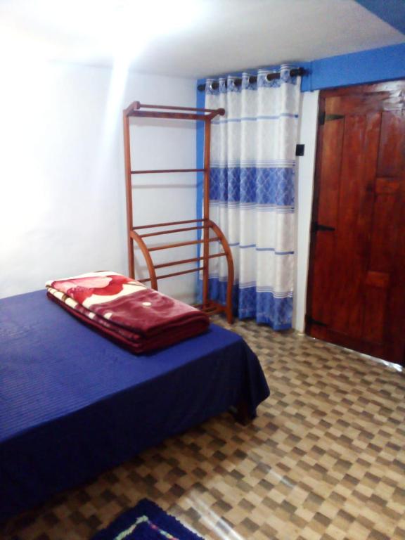 a room with a bed and a ladder next to a door at RK Guest in Nanu Oya