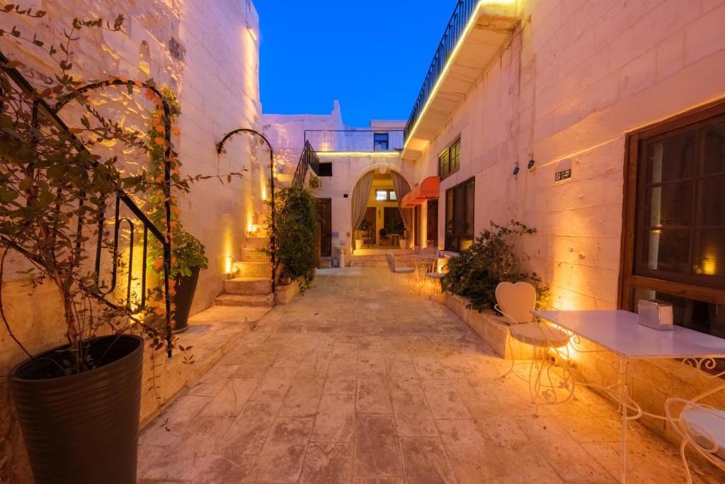 an empty alley with tables and chairs in a building at Old Town Urfa in Urfa