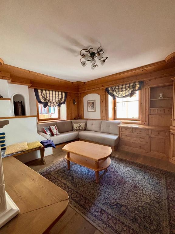a living room with a couch and a table at Pragma Apartments - Casa Defrancesco in Cavalese