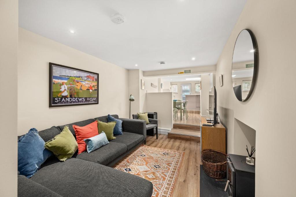 a living room with a couch and a tv at 114 North Street in St. Andrews