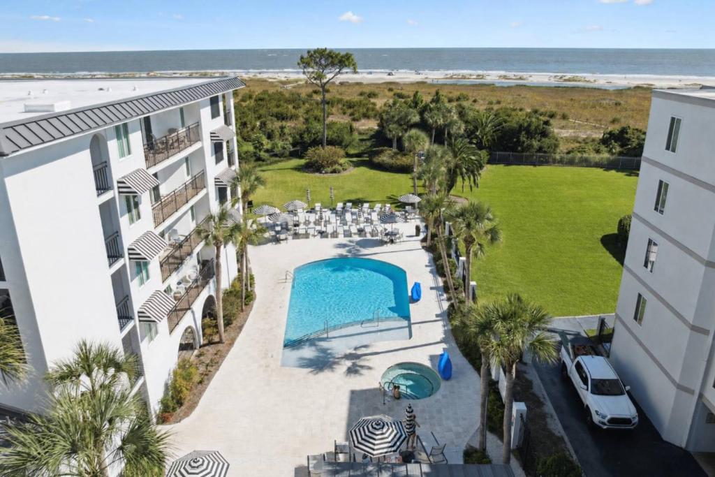 an aerial view of a resort with a swimming pool and the beach at North Breakers 201 in Saint Simons Island