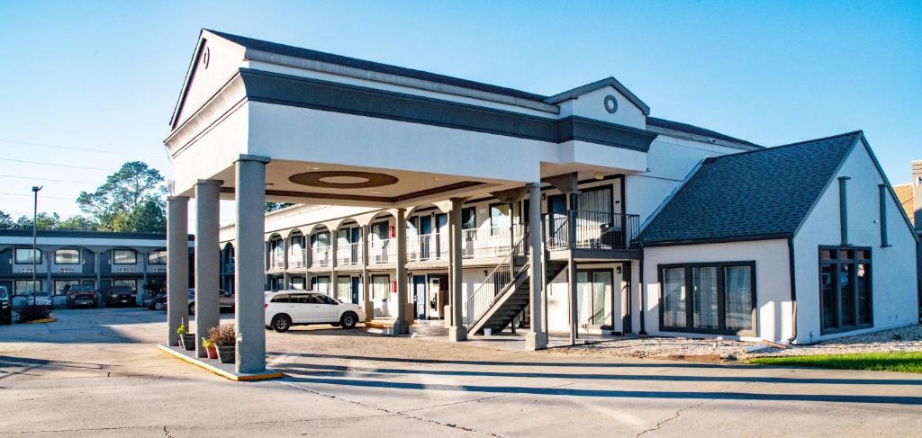 a building with a car parked in front of it at Studio 6 Suites Opelousas, LA in Opelousas