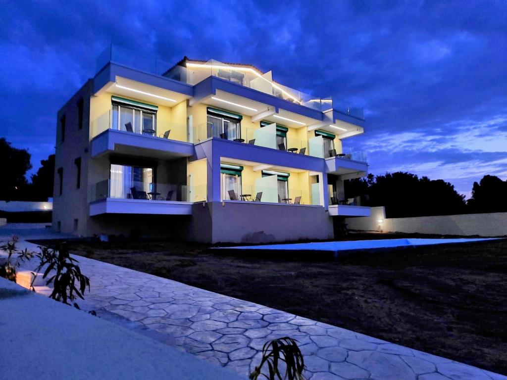 a large white building at night with a sky at AIR-IN Rooms with magnificent views in Spata