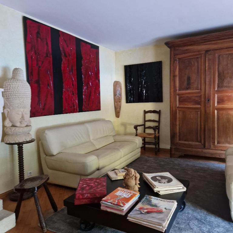 a living room with a couch and a table at Chez raymonde in Teyran
