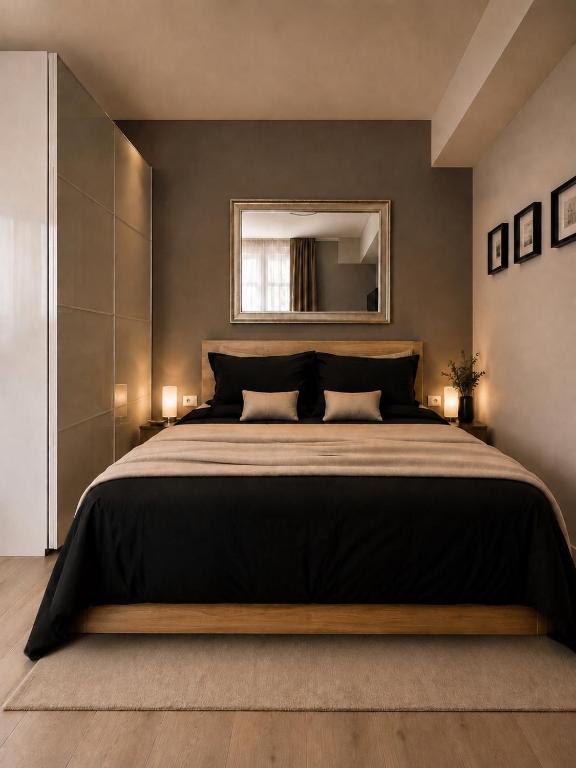 a bedroom with a large bed and a mirror at Parkside Amphitheatre Apartments with private parking in Pula